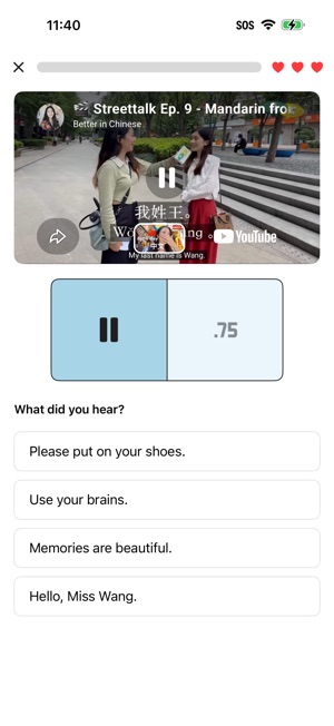 A library battle over a saved YouTube street interview. The clip plays one line, with a pause button and a 0.75 speed control beneath it, and the question What did you hear? offers four answers, among them Hello, Miss Wang. Three hearts show the lives left.